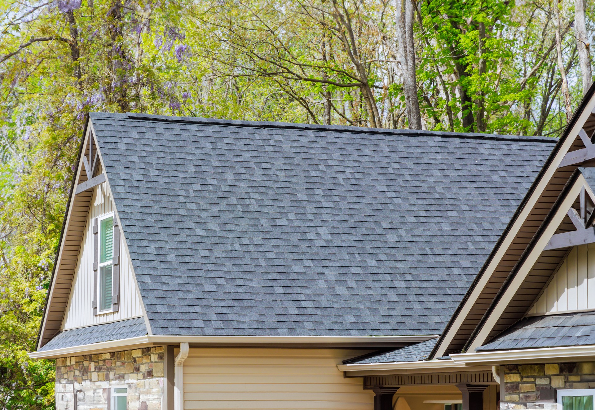 Asphalt shingles are used as roofing materials on roof of a newly constructed house